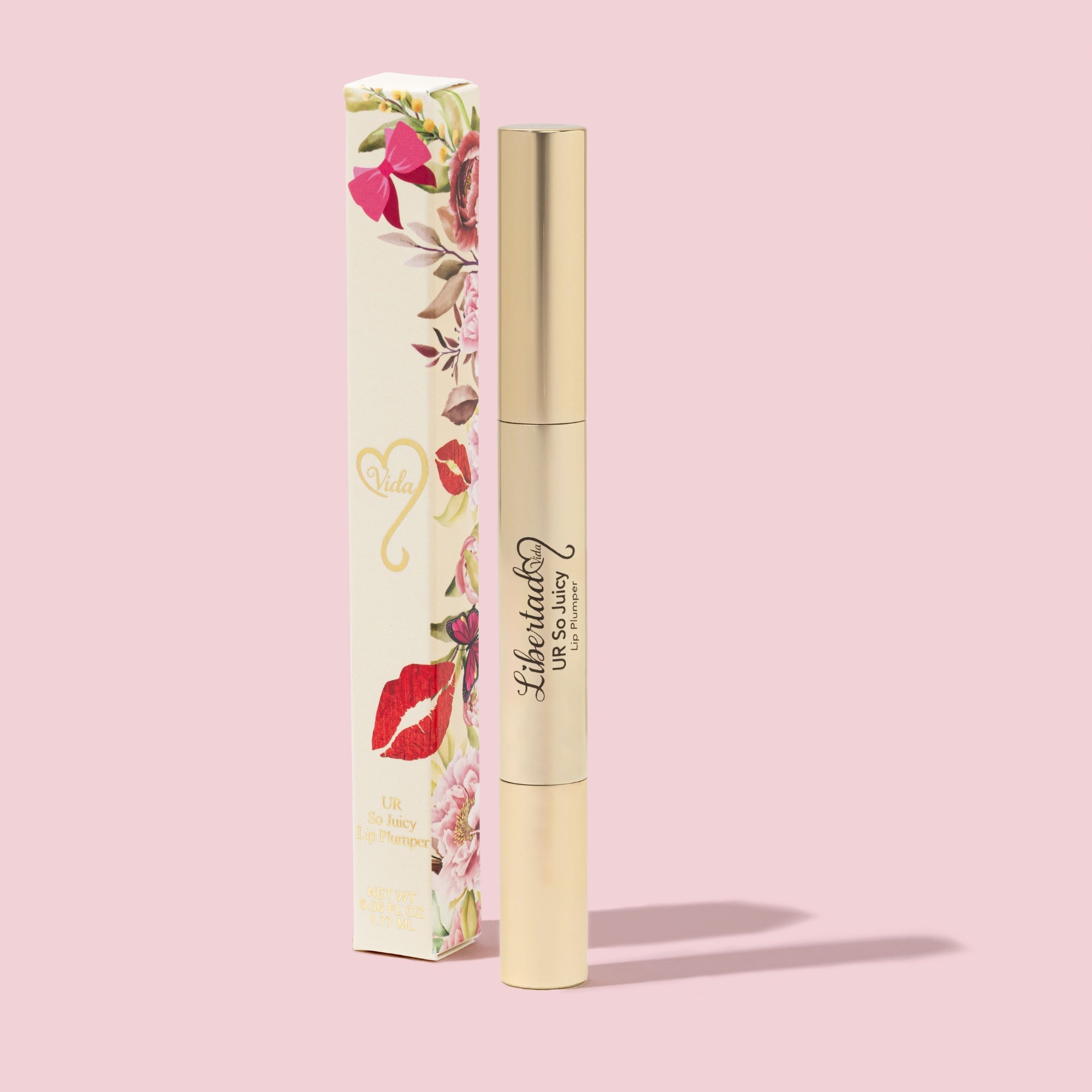 Lip plumper with floral packaging on a pink background